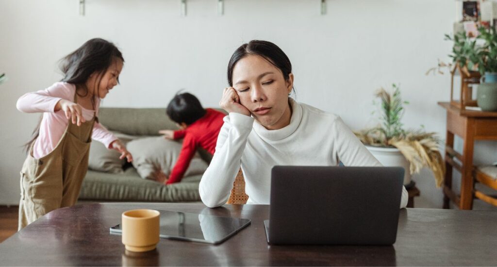 Exhausted mother trying to work